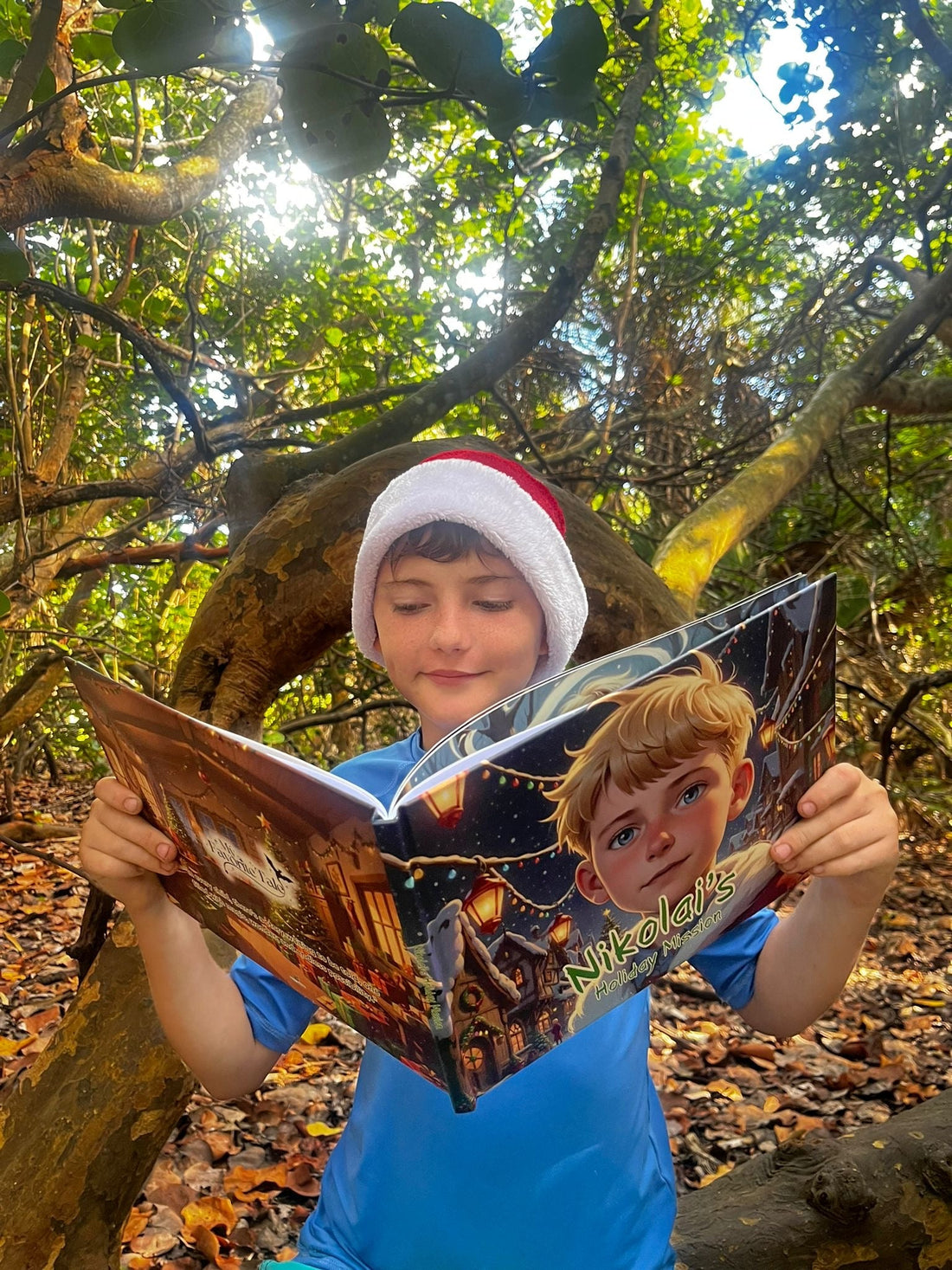 Boy in a Santa hat reading his personalized Christmas storybook