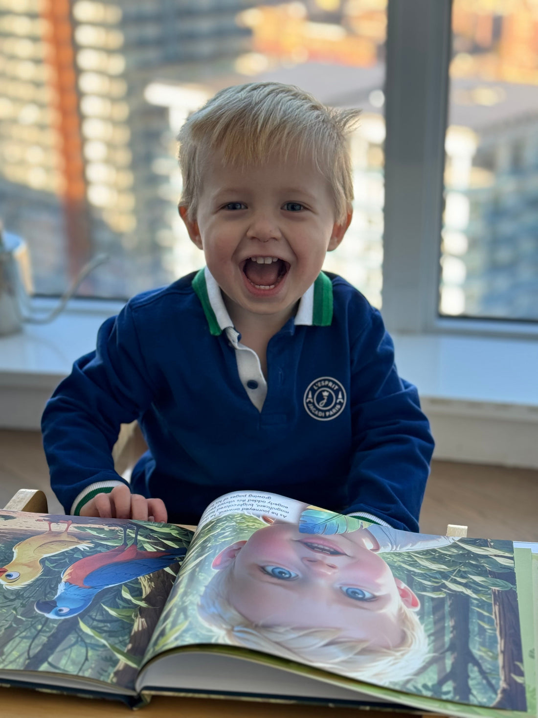 Toddler laughing as he looks through his personalized storybook